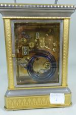 Pendule d'officier en bronze,métal amati et verre à décor de...