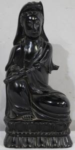 Sujet en bois laquée noir représentant la déesse Guanyin assise...