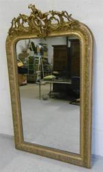Miroir en bois doré sculpté de motifs de rinceaux et...