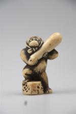 Netsuke en ivoire et rehauts bruns représentant un singe habillé...
