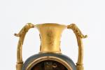 PENDULE urne en bronze ciselé, doré et patiné à décor...