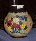 MASSIER. Vase boule en faïence à décor floral polychrome et...