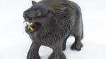 SUJET "Lion" en bois sculpté et décor d'incrustations d'ivoires aux...