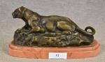 BARYE (L.) "Lionne couchée", bronze à patine brune et or,...