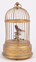 Cage à un oiseau chanteur
en métal doré. Bel état. Fonctionne...