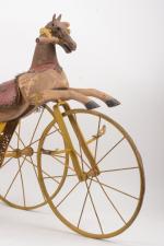 Cheval tricycle en bois
sur trois roues en fer, tête en...