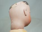 Une poupée à tête de porcelaine, H : 64 cm,...