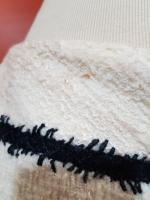 CHANEL - Un tailleur en laine écru et noir composé...