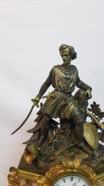 Pendule à décor de chevalier en bronze et régule à...