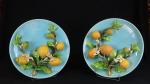 Deux plats en barbotine à décor en relief de citrons...
