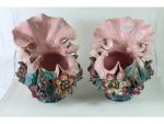 Une paire de vases en barbotine à décor floral polychrome...