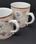 Deux chopes en porcelaine - monogrammées C.M. en médaillon fleuri...