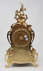 Une pendule en bronze doré - à décor de rinceaux...