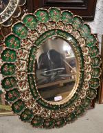 Un miroir, cadre en bois doré et parecloses décor de...