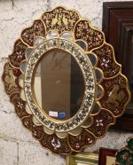 Un miroir, cadre en bois doré et parecloses décor de...