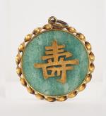 Chine, XXe siècle, 
Pendentif en jadeite cerclé de cuivre doré...
