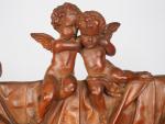 Miroir XIXème en bois sculpté à décor d'amours dans une...